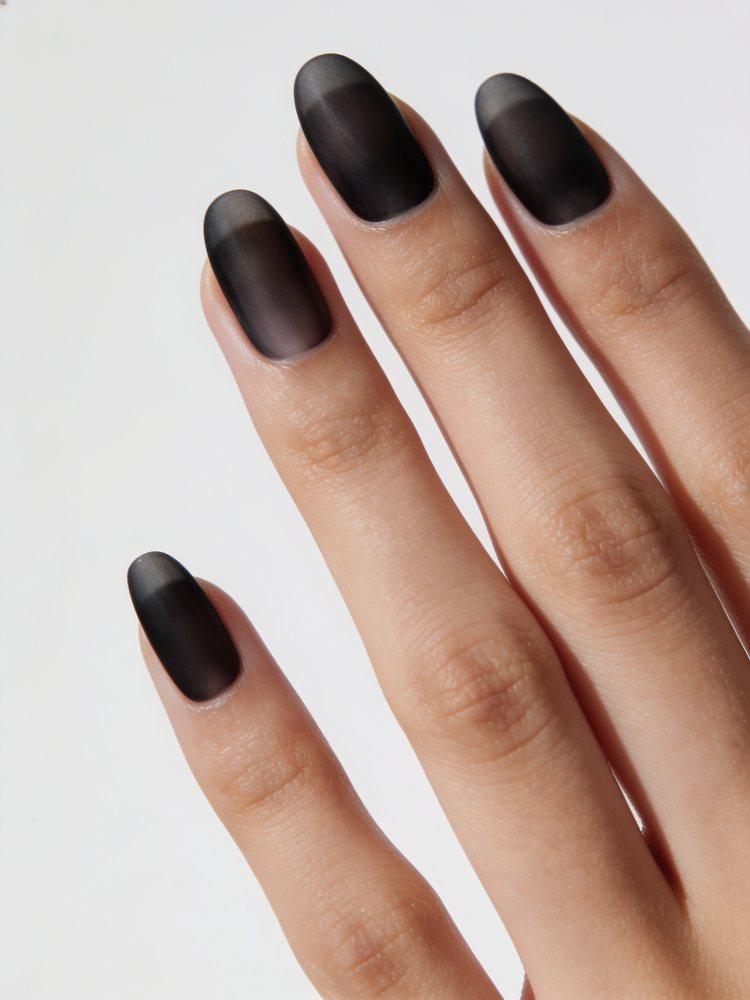 Short almond nails in a sheer smoky black wash