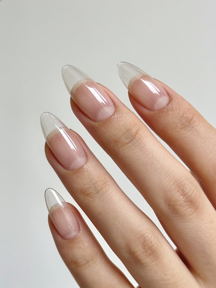 Very short natural nails with clear gloss and neat shaping