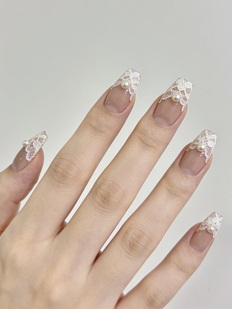 Medium almond nails with a lace French tip and small pearls