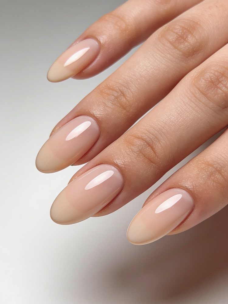 Medium oval nails with a soft egg-shaped tip in milky white