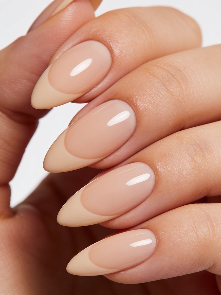 Long almond nails tapering to a soft rounded point in glossy blush pink
